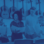 Young people studying guitar sheet music