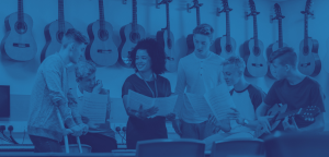 Young people studying guitar sheet music