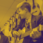 School children learning guitar